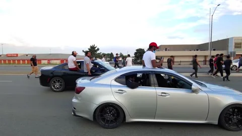 Tracking shot right next to car riders on window frames while making noise Stock Footage 136854334