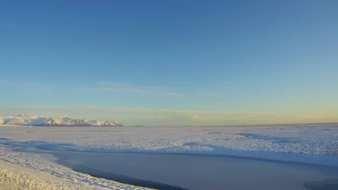 Tracking shot right side view camera moves in a snowy landscape, frozen lakes Stock Footage 95197374