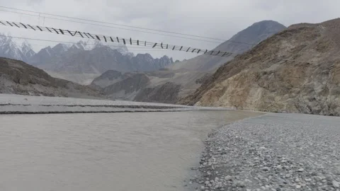 Tracking Shot of a River Flowing Through a Mountainous Landscape in Pakistan 스톡 동영상 317958356