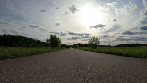 Tracking shot of road across a field Stock Footage 169088865