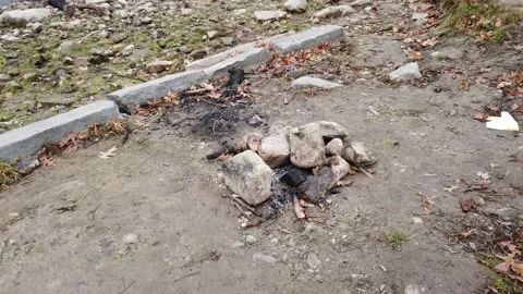 Tracking shot of a rock fire pit  by a river Stock Footage 144052897