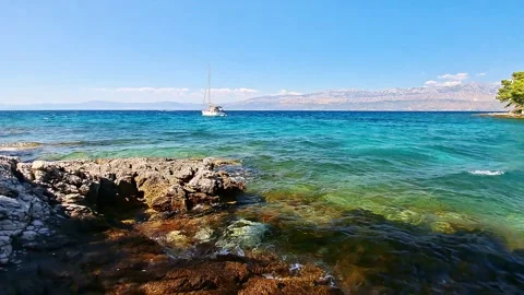 Tracking shot of a sailboat in a bay on Brač island 스톡 동영상 316600474