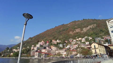 Tracking shot, shooting Como lakeshore view while walking on pier. Stock Footage 255879003