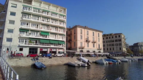 Tracking shot, shooting Como lakeshore view while walking on the pier walkway. Stock Footage 255879006