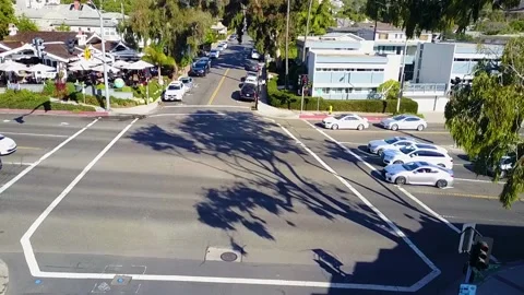 Tracking shot on silver car driving down cliff drive in Laguna Beach California Stock Footage 155460607