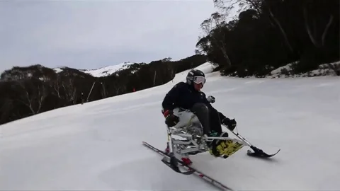 Tracking shot - Skiir moving down a slope Stock Footage 81498672