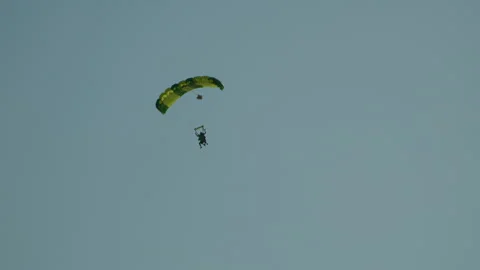 Tracking shot of skydiver flying in the air against blue sky in Poland - Stock Footage 245489224