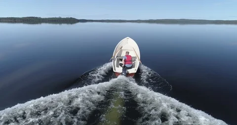 Tracking Shot of the Small Boat on a Tranquil Undisturbed Lake Stock Footage 85889268