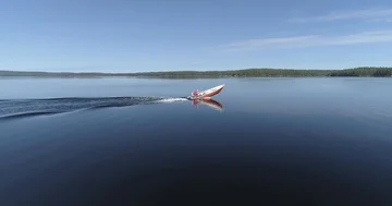 Tracking Shot of the Small Boat on a Tranquil Lake in Middle of a Forest Stock Footage 85890276