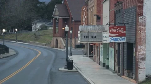 Tracking Shot of small town street with two cars going by (HD) Stock Footage 65502575