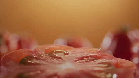 TRACKING SHOT ON A SPINNING SLICE OF TOMATO Stock Footage 132780902
