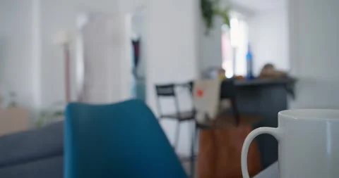 A tracking shot from a steaming cup of coffee to a laptop. Stock Footage 334651983