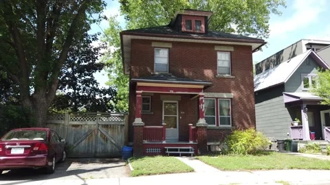 Tracking shot of a street of homes in the down town Stock Footage 136958862