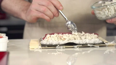 Tracking shot of sushi chef placing asparagus on fresh tuna and crab roll Video stock 92234089