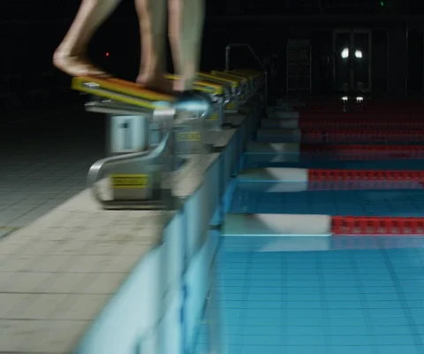 Tracking shot of swimmer diving into pool and swimming, Japan Stock Footage 147059447