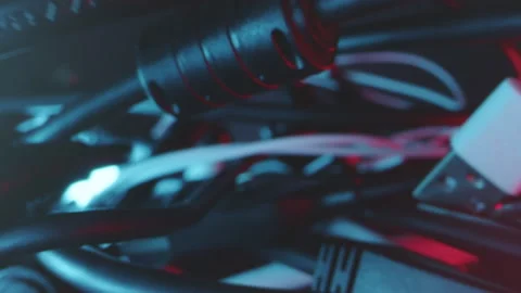 Tracking shot of tangle of different cables and adapters in technical light Stock Footage 220792060