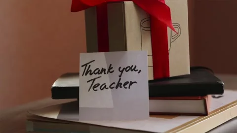Tracking shot of Teacher appreciation gift on classroom desk Stock Footage 340139258