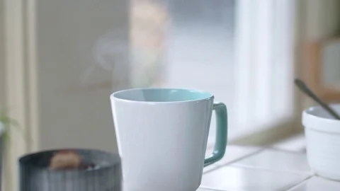 Tracking shot of teal mug filled with steaming hot water Stock Footage 84473580
