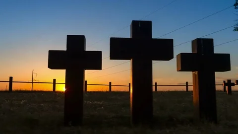 Tracking shot of Three massive stone crosses on the graves of the old cemetery Video stock 75328931