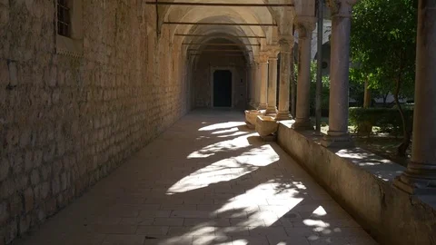 Tracking shot through archway of old Benedictine monastery on Lokrum Stock Footage 71177685