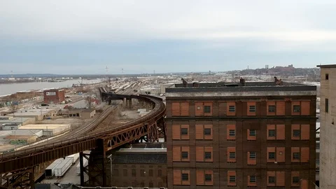 Tracking shot through old industrial area with train track Stock Footage 104876120