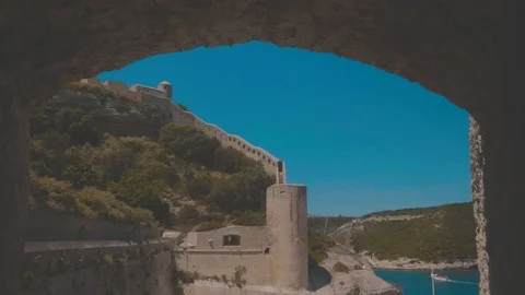 Tracking shot through a old stone window of a seaside fortress in Corsica Stock Footage 88903536