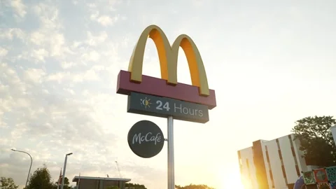 Tracking shot towards Mc Donalds Logo in a Sydney street 6K Video stock 307825217