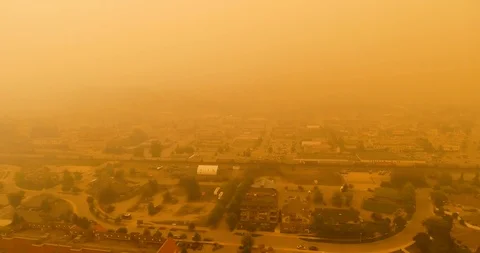 Tracking shot of train traveling through thick smoke in small BC town in Canada Stock Footage 94153209