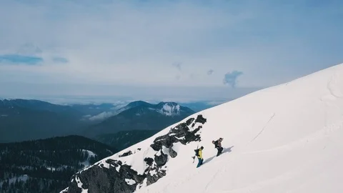 Tracking shot two active people climbing on top of high mountain at winter sunny Vídeos de archivo 120833499