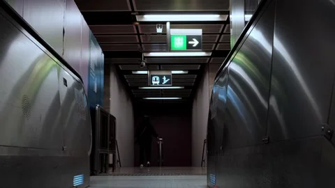 Tracking shot on a upward escalator in a metro station to the top. 스톡 동영상 249710161