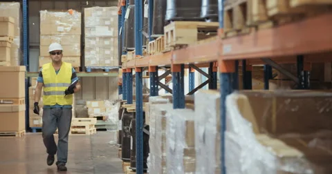 Tracking shot of a warehouse worker walking  Stock Footage 65039523