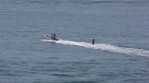 Tracking shot of water skier in open  ocean being pulled by a motorized dingh Video stock 67612281