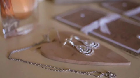 Tracking shot of wedding and bridal accessories on a table, close-up Stock Footage 65952086