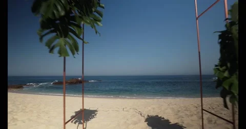 Tracking shot of an wedding event on an empty Cabo San Lucas beach. Stock Footage 134594291