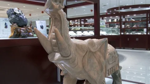 Tracking shot of white jade elephant in a Chinese jade shop, 4K. Stock Footage 79703580