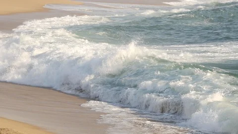 Tracking shot of white ocean wave moving across ocean surface towards beach Stock Footage 105162916