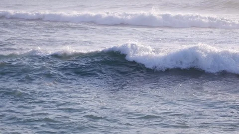 Tracking shot of white ocean wave moving toward beach Stock Footage 105164739