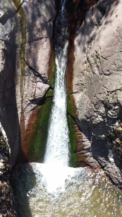 Tracking shot of wilderness cascade pouring into stone basin in Kazakhstan Видео 338125337