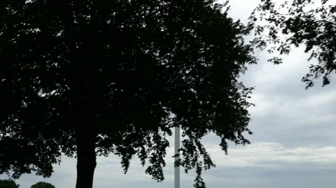 Tracking shot of wind turbines for clean wind energy behind the trees Stock Footage 67894120