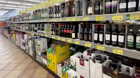 Tracking shot of wine bottles displayed on shelves Stock Footage 313807433