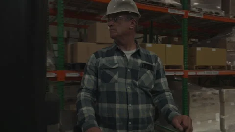 Tracking shot of worker driving forklift in warehouse / American Fork, Utah, Stock-Footage 275543502