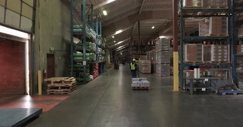 Tracking shot of a worker pulling a pallet truck 스톡 동영상 76225466