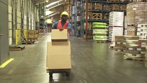 Tracking shot of a worker pushing a trolley Video stock 76534807