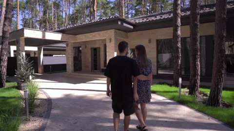 Tracking Shot of Young Couple Walking Together to the Modern House  Stock Footage 138896481