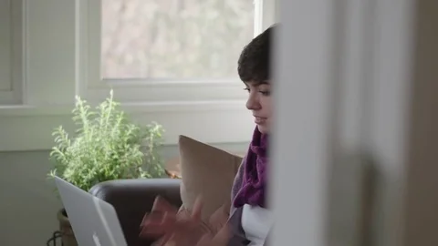 Tracking shot of young lady showing her frustration over slow internet Stock Footage 70809452