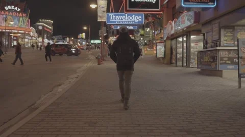 A Tracking Shot Of A Young Man Walking At Night Stock Footage 247453072