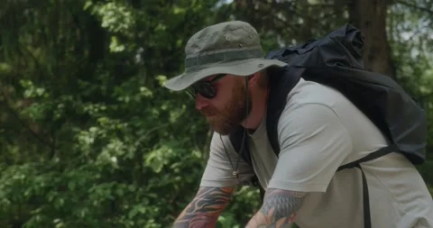 Tracking side shot of cyclist riding through forest Stock Footage 311934480
