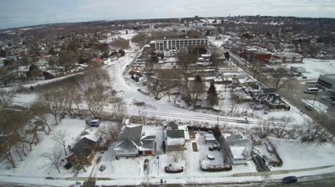 Tracking Sideways Over an old Neighborhood in the Snow Stock Footage 61736593