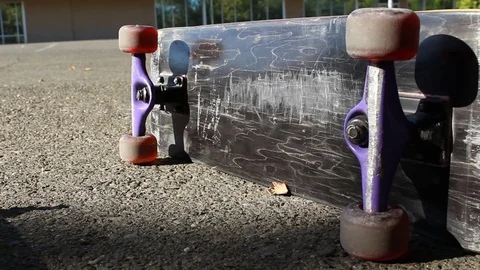Tracking Up Skateboard on its Side in Parking Lot Extreme Sports Dolly Shot Stock Footage 114035679