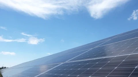 Tracking slider close up of solar panels tilt up to clouds Stock Footage 78040763